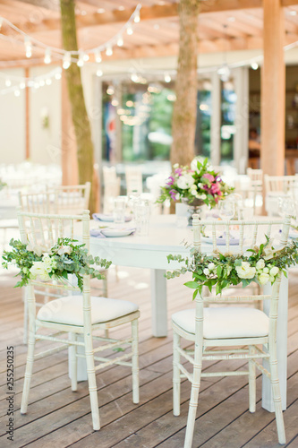 chairs with flowers and eucalyptus