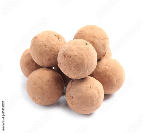 Delicious raw chocolate truffles on white background