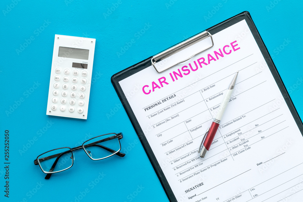 Car insurance form near glasses, calculator, pen on blue background top view Car insurance form near glasses, calculator, pen on blue background top view