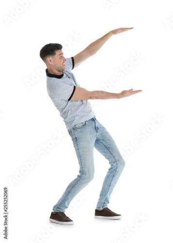 Man in casual clothes holding something on white background
