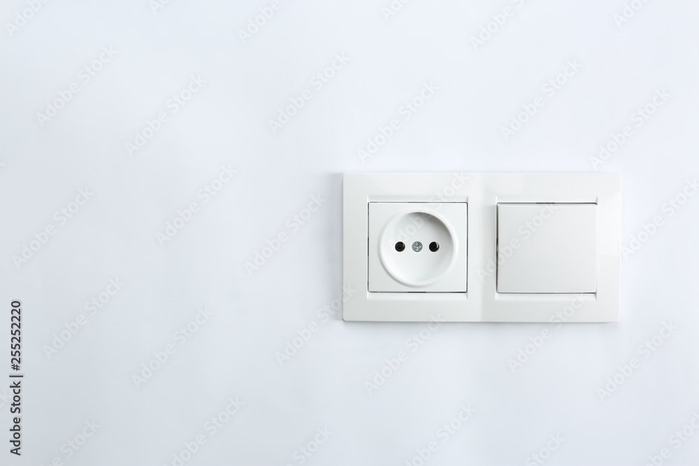 Light switch and power socket on white background. Electrician's equipment Light switch and power socket on white background. Electrician's equipment