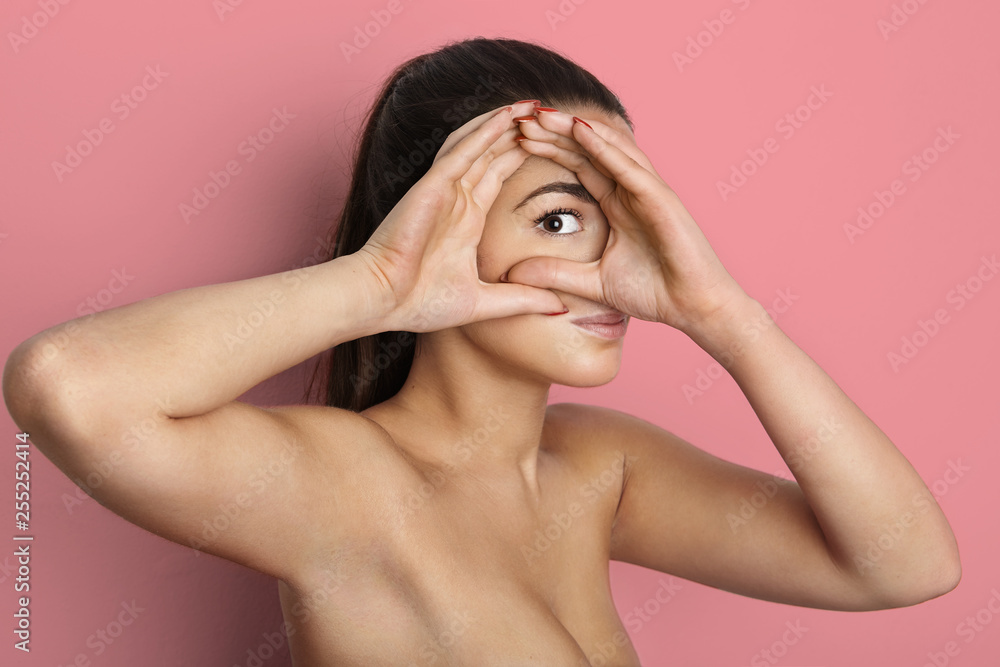 Portrait of beautiful young female woman with long curly hair, over pink background.Vogue style portrait of beautiful delicate woman Portrait of beautiful young female woman with long curly hair, over pink background.Vogue style portrait of beautiful delicate woman