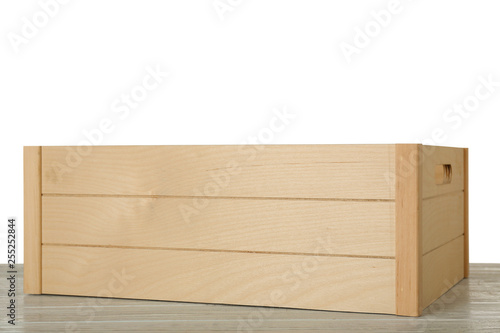 Empty rustic wooden crate on table against white background