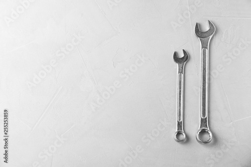 New wrenches on grey background, top view with space for text. Plumber tools © New Africa