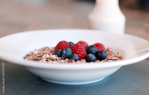 close up breakfast granola with berries and milk