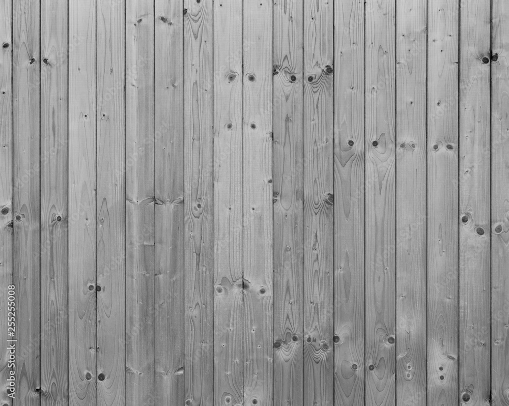 Full frame background of a new, clean and unpainted wood board wall in black and white.