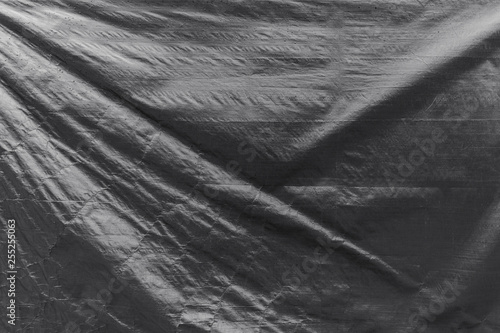 Slika na platnu Full frame background of a wrinkled tarp texture in black and white