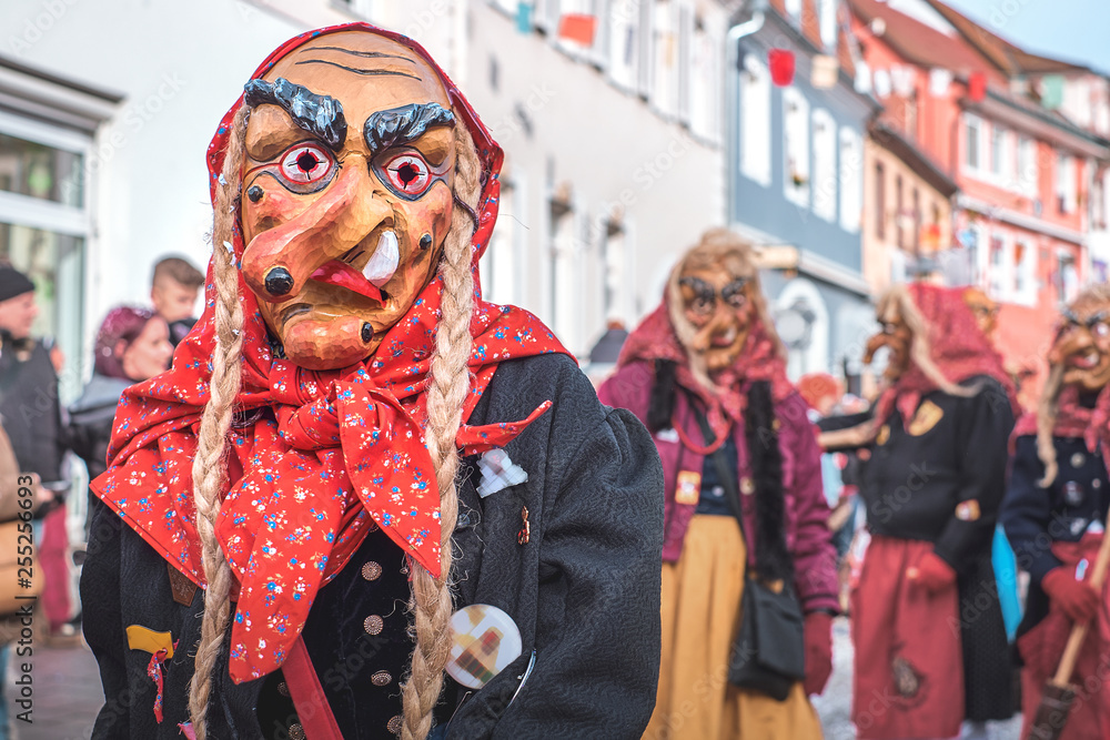 Carnival figure with a crooked nose and pigtails. Street Carnival in Southern Germany - Black Forest.