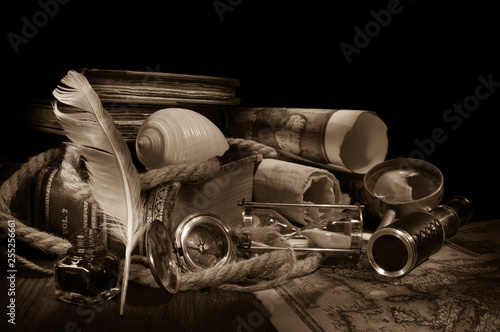 Old maps and vintage objects on a wooden table, sepia effect © siculodoc