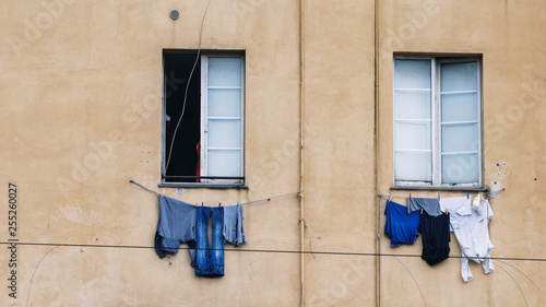 Linen drying hanging from the windows on the streets of the city of Genoa  Italy
