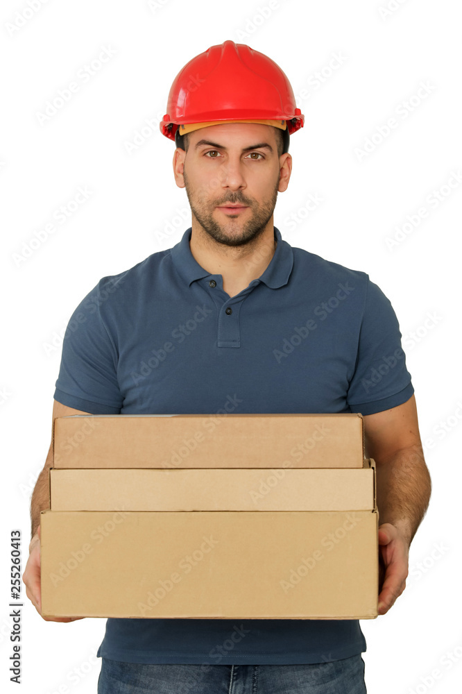 Young handsome worker in red helmet holding cardboard boxes, studio shot isolated on white Young handsome worker in red helmet holding cardboard boxes, studio shot isolated on white