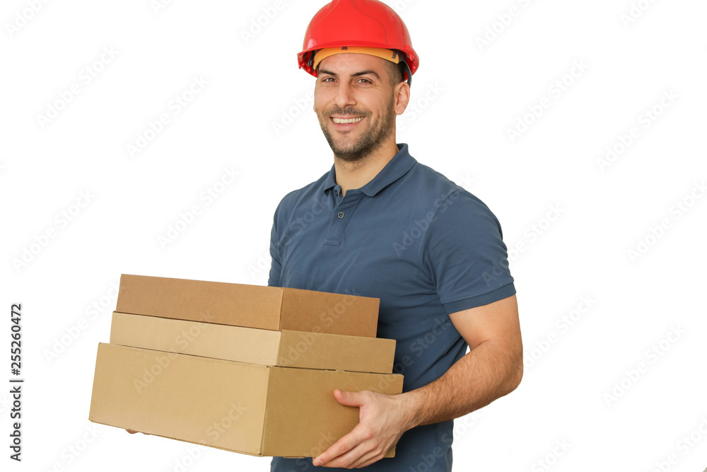 Young handsome worker in red helmet holding cardboard boxes, studio shot isolated on white Young handsome worker in red helmet holding cardboard boxes, studio shot isolated on white