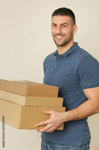 Young man holding cardboard box