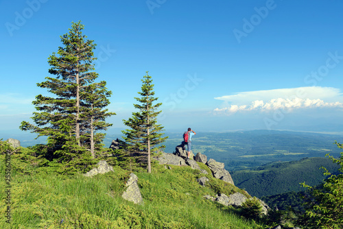 Young man in the mountain Panoramic view Summertime Selective focus