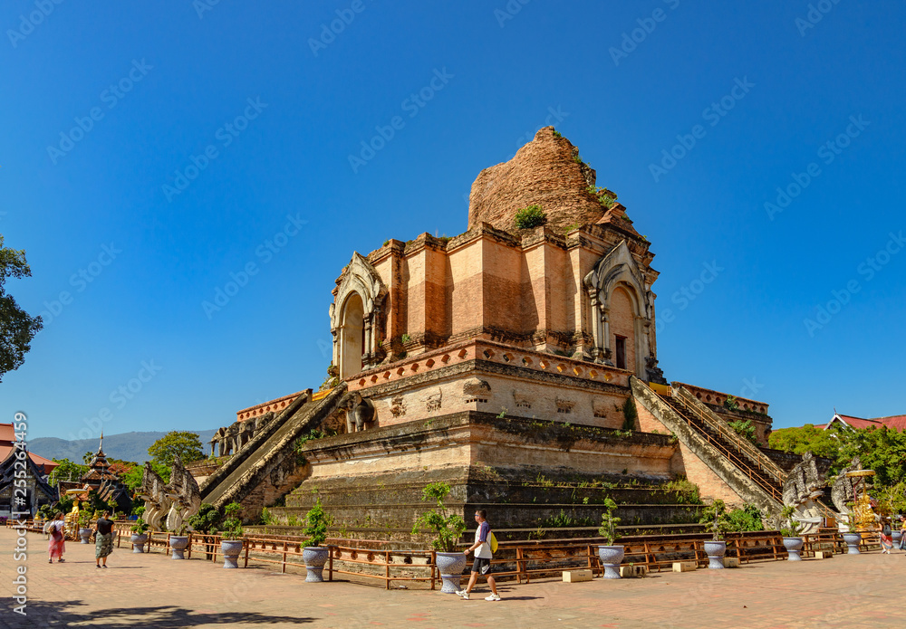 Outdoor sunny view of ruin brick remains of pagoda in Thai temple, Wat Chedi Luang, famous and renown historical religious architecture in Northern Thailand.
