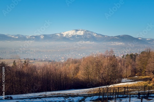 Beautiful winter mountain landscape. A glade on a mountain slope with a mountain route.