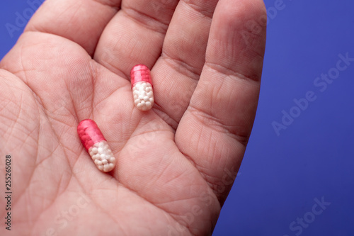 Close-up shot of a hand holding two pills