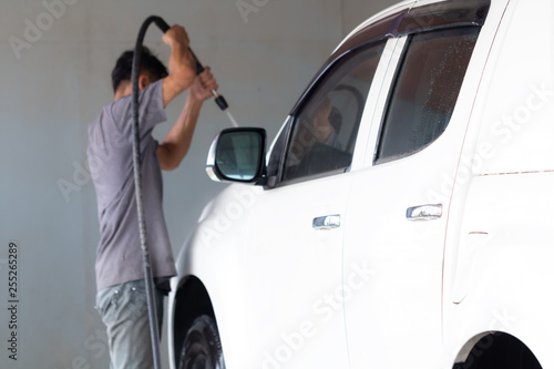 Employees worker washing car in the car wash shop. © JC_STOCKER