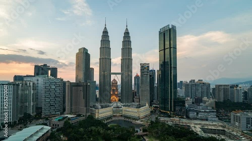 KUALA LUMPUR, MALAYSIA - MARCH 14, 2019: 4K Cinematic Sunset Panning Left to Right Time Lapse Footage of the PETRONAS Twin Towers and Kuala Lumpur City Skyline.