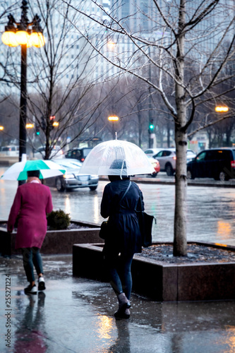 people walking on the street in the rain