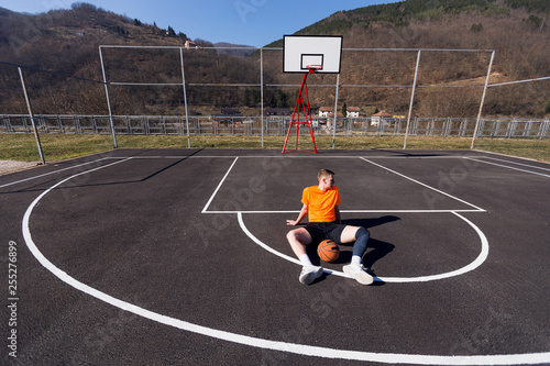 Basketball player at street court © Novak