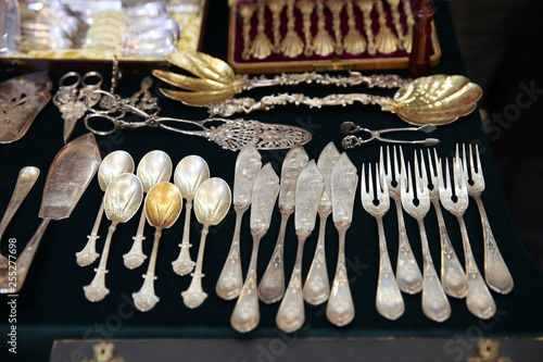 Antique silver Cutlery, spoons, forks, knives on the shelf of the flea market.