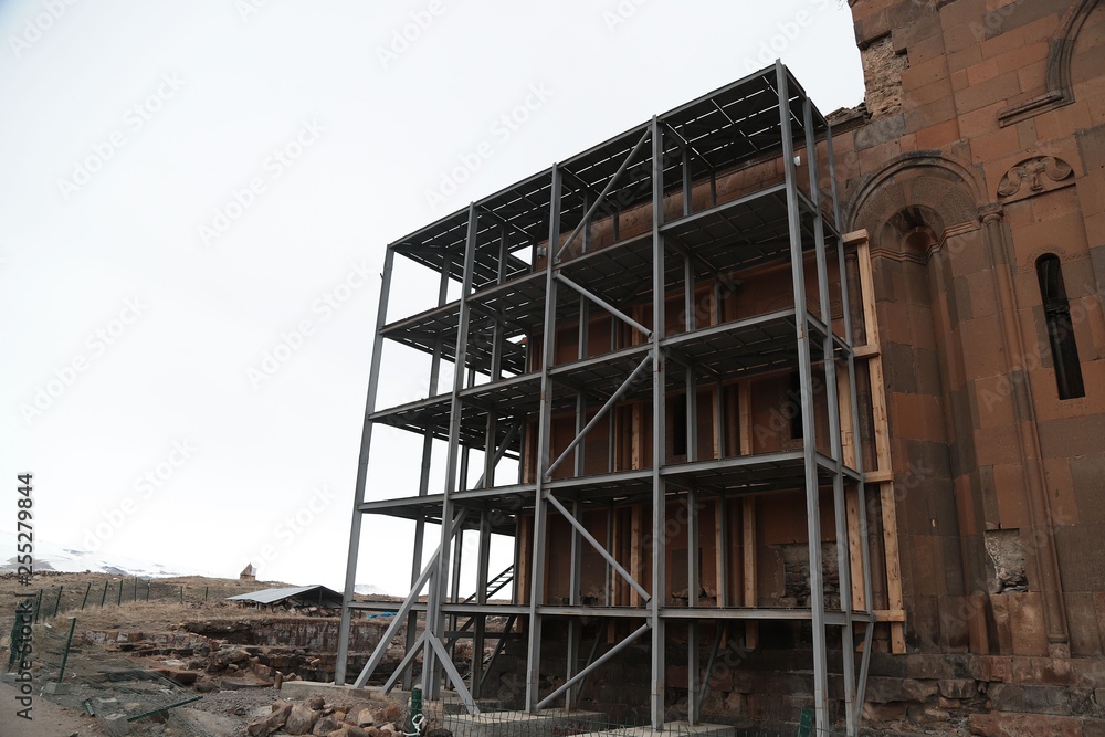 Restoration of old wooden churche against the gray sky. Kars