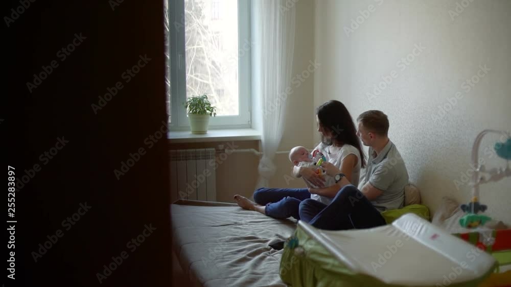 Man and Woman with Baby on her Arms are Talking Man and Woman with Baby on her Arms are Talking
