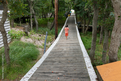 boy on boardwalk fire island