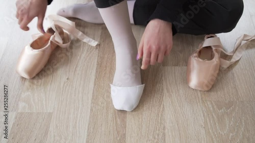 close-up shot of ballerina wearing ballet shoes
