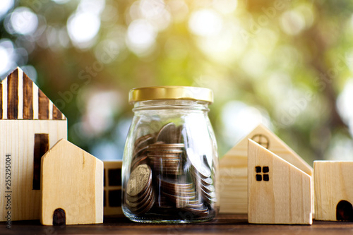 Little wood house model with coins saving for residential .