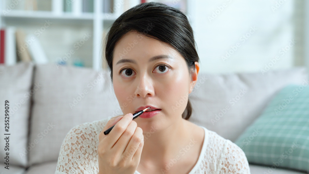 Young Asian cute artist woman beauty vlogger doing cosmetic makeup tutorial vlog with brushes on lips. female blogger recording viral clip share on social media live streaming Internet concept. Young Asian cute artist woman beauty vlogger doing cosmetic makeup tutorial vlog with brushes on lips. female blogger recording viral clip share on social media live streaming Internet concept.