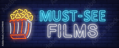 Must-see films neon text with popcorn paper box