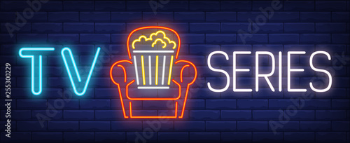 TV series neon text with popcorn bucket in armchair