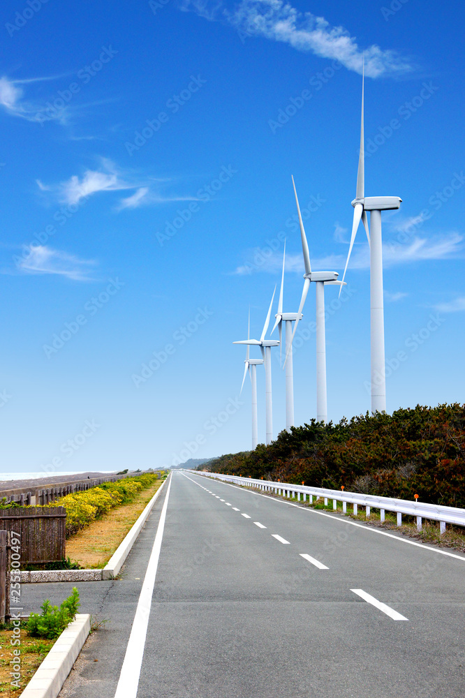 風力発電の風車とまっすぐな道