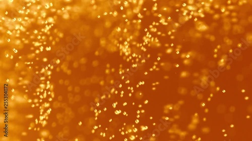 Macro Shot Of Fine Bubbles Rising In A Glass With Orange Liquid