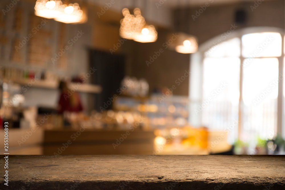 image of wooden table in front of abstract blurred background of resturant lights image of wooden table in front of abstract blurred background of resturant lights