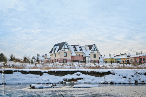 Beautiful two-story cottage by the river in winter