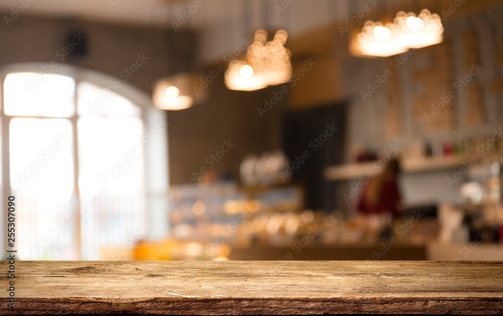 image of wooden table in front of abstract blurred background of resturant lights image of wooden table in front of abstract blurred background of resturant lights