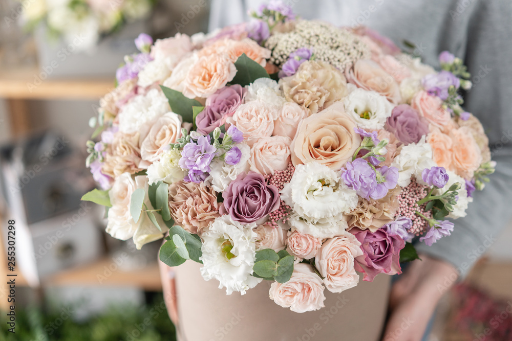 beautiful fresh cut bouquet of mixed flowers in woman hand. the work of the florist at a flower shop. beautiful fresh cut bouquet of mixed flowers in woman hand. the work of the florist at a flower shop.