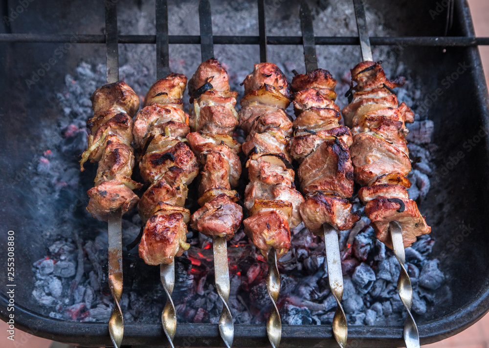 cooking grilled shish kebab on metal skewer fresh meat. cooked at barbecue bbq roasted beef meat cooking grilled shish kebab on metal skewer fresh meat. cooked at barbecue bbq roasted beef meat