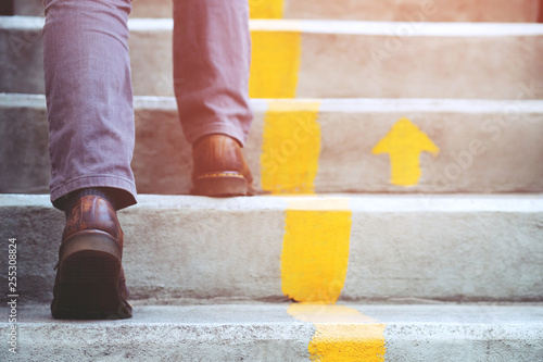 Принти на полотні modern businessman working close-up legs walking up the stairs in modern city