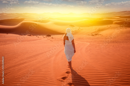 woman in beduin dress in desert