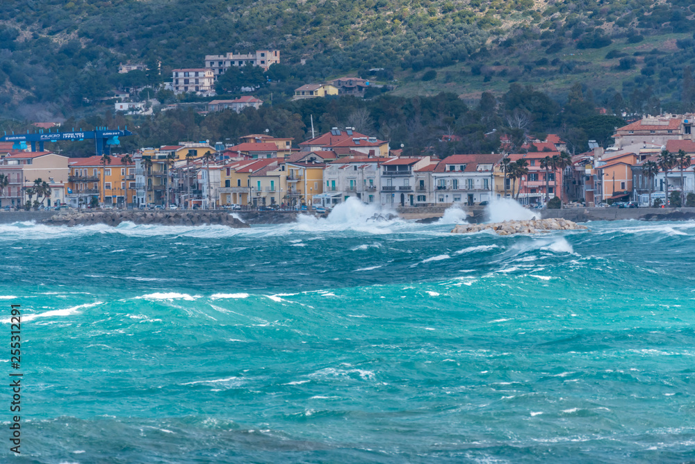 Fototapeta premium Stormy and Windy Mediterranean Sea with a Village in the Distance
