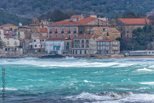 Stormy and Windy Mediterranean Sea with a Village in the Distance