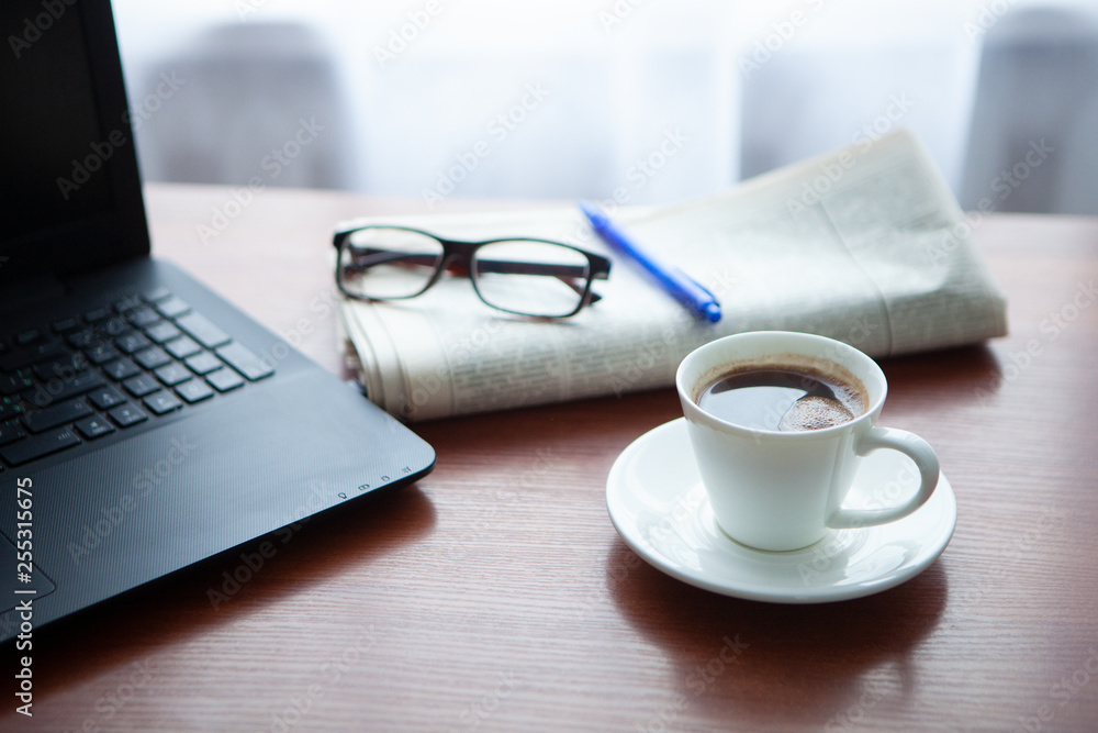 Newspaper with computer on table. Coffee break. Newspaper with computer on table. Coffee break.