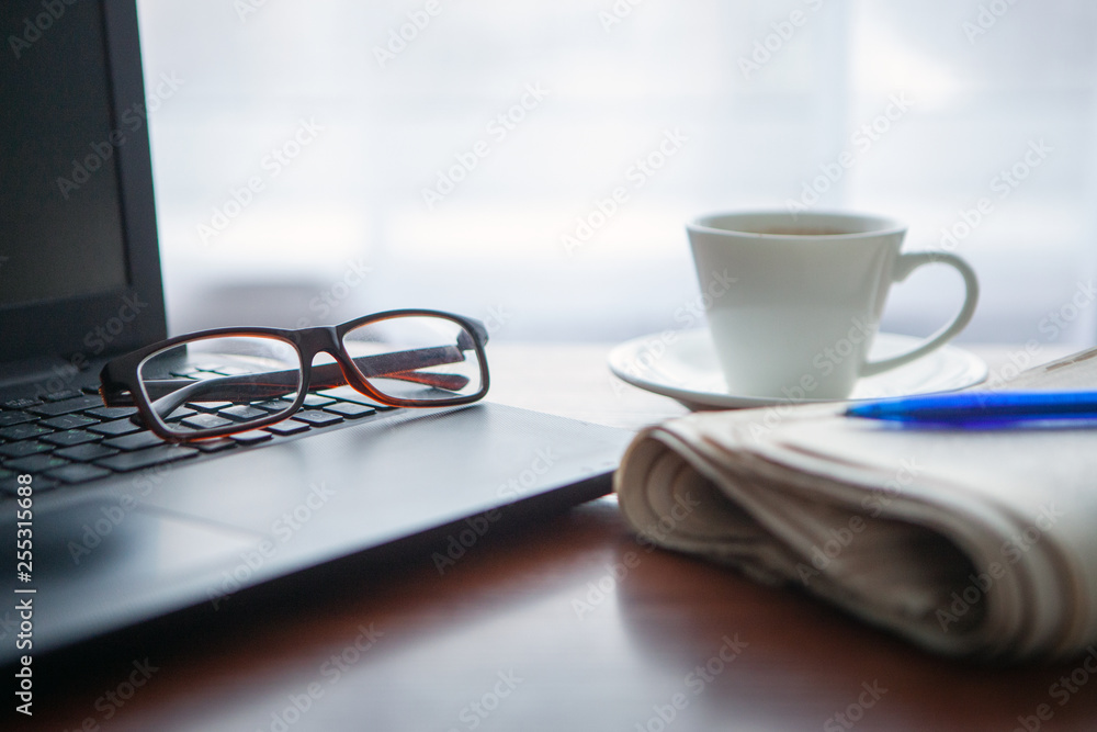 Newspaper with computer on table. Coffee break. Newspaper with computer on table. Coffee break.