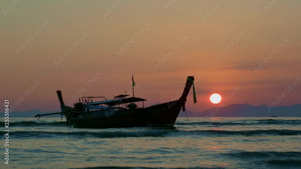 Traditionnal Long tail boat at sunset in Thailand Traditionnal Long tail boat at sunset in Thailand