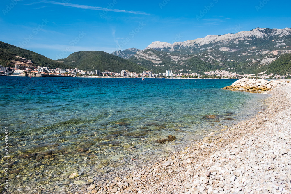 Mediterranean beach panorama view. Blue summer sky over Adriatic Sea landscape. Montenegro. Europe.