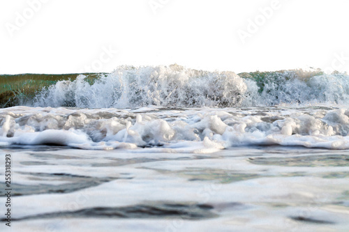 powerful foamy wave runs in a coast